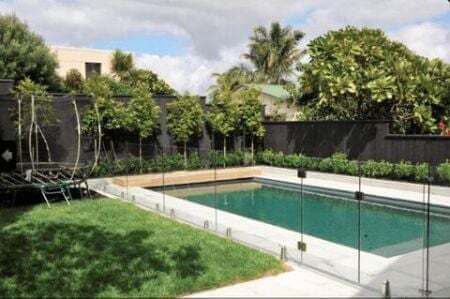 In ground concrete pool, Quatzite plaster finish, Peuter honed tiles. A walk on pool cover, Glass balustrade.